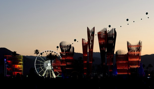 The sun sets as festival goers move about the Coachella Valley Music and Arts Festival at the Empire Polo Club in Indio on Sunday, April 21, 2024. (Photo by Jennifer Cappuccio Maher, Contributing Photographer)